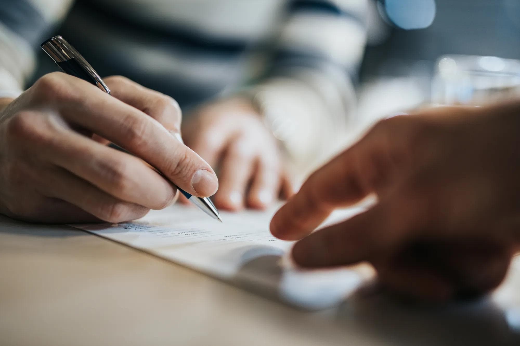 Close up of someone signing contract 