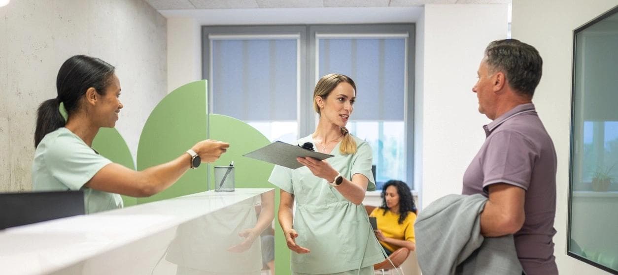 Healthcare professionals discussing treatment options with a patient in a clinic. 