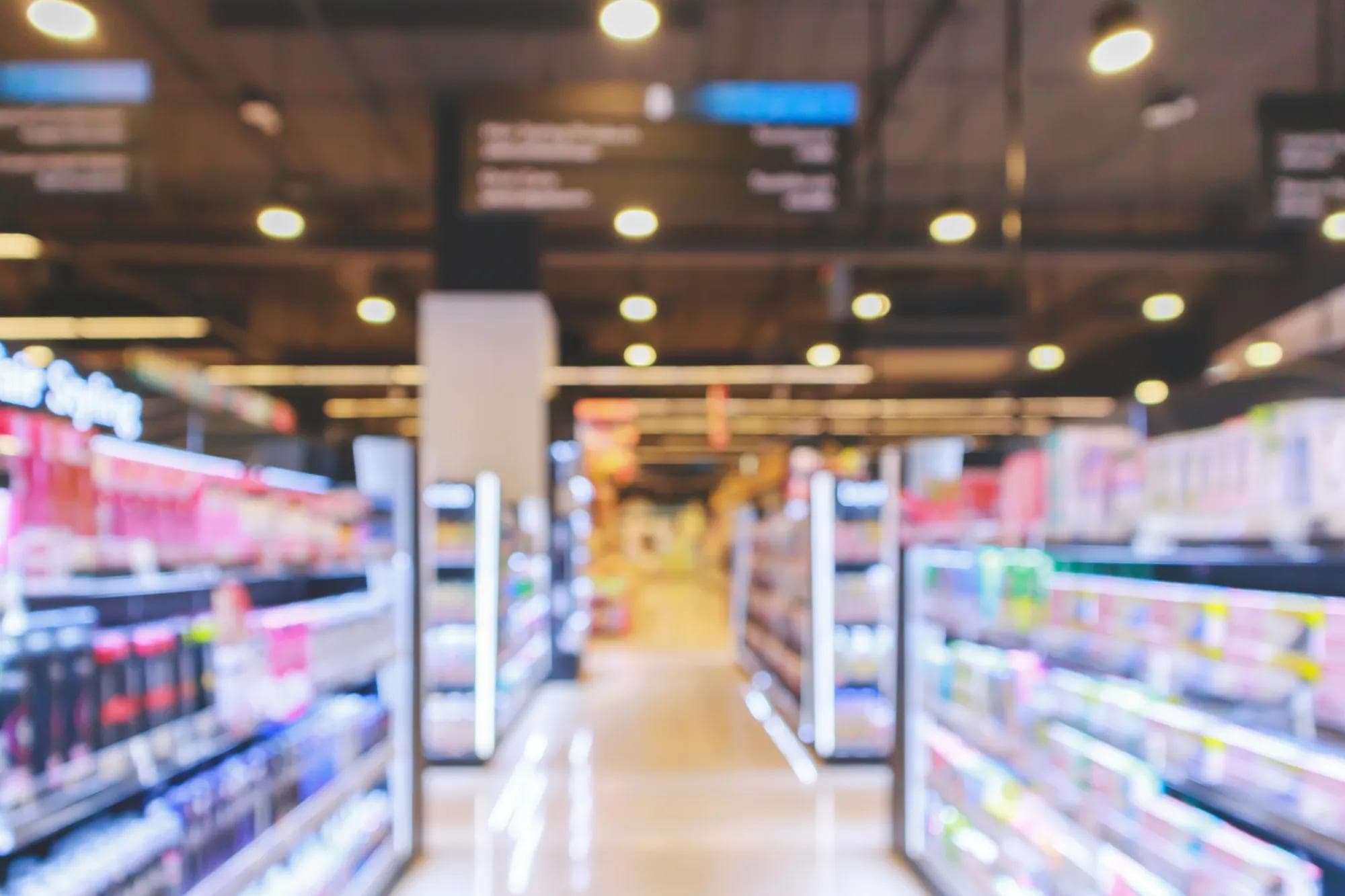 Supermarket aisle with cosmetic healthcare product shelves interior: