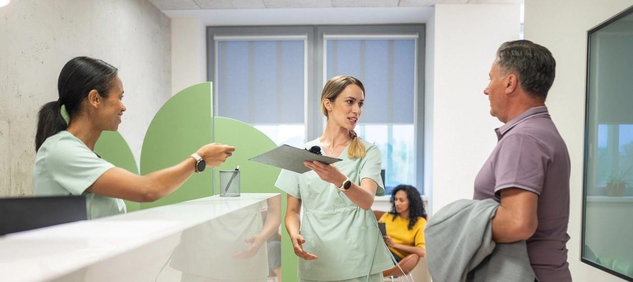 Healthcare professionals discussing treatment options with a patient in a clinic. 