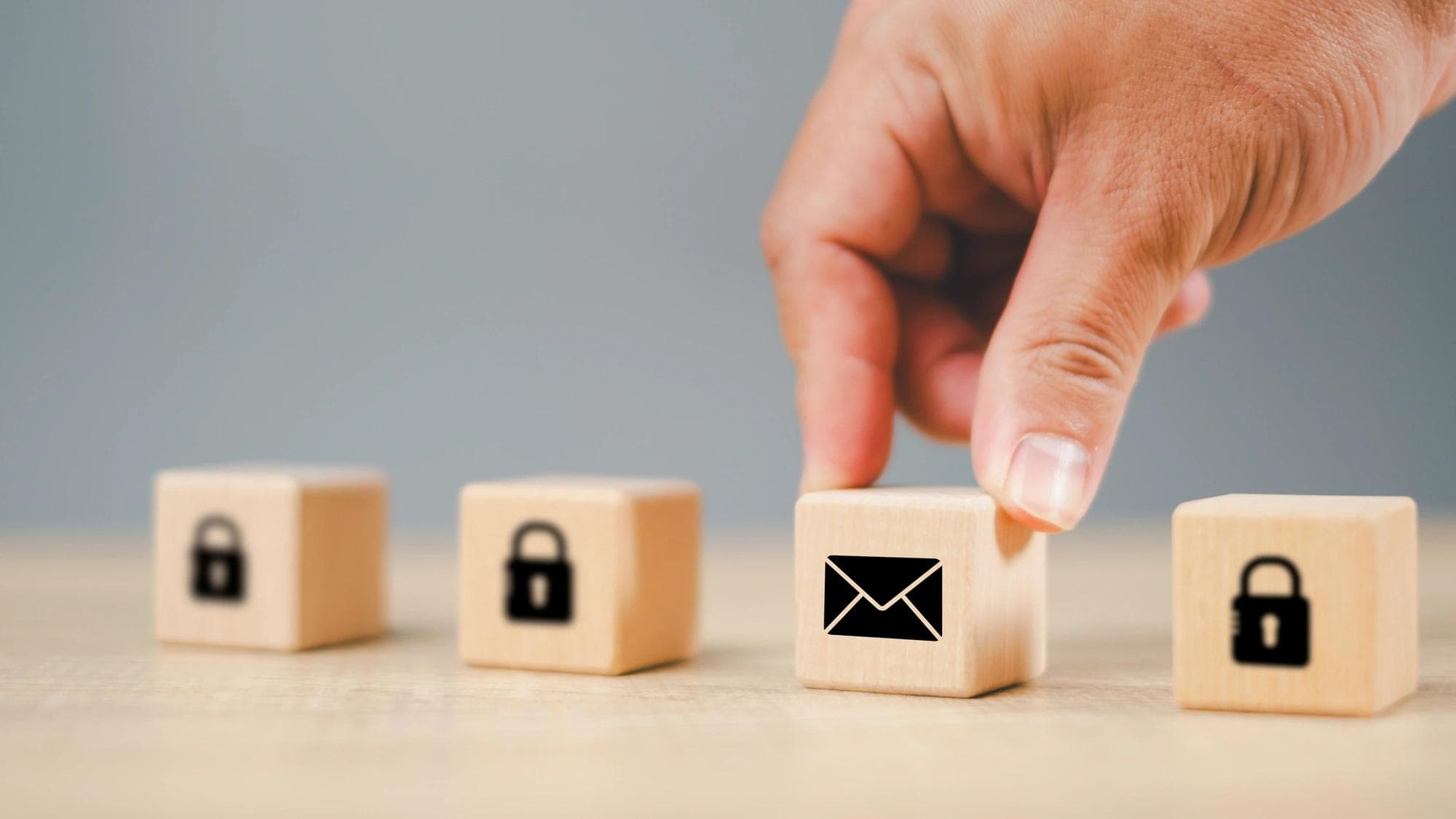 Wooden blocks showing envelope and lock icons, symbolizing cybersecurity controls.