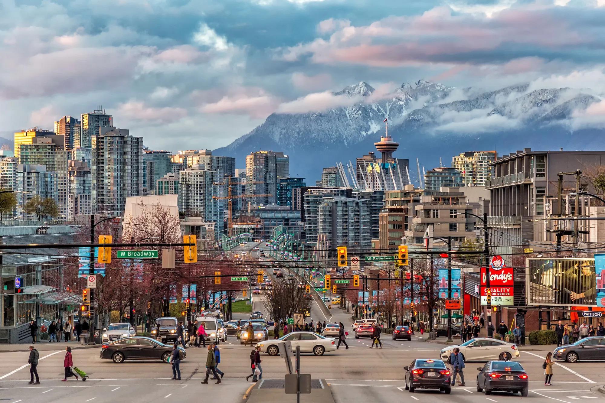 A view of Vancouver downtown with a snow-covered mountain in the background. 