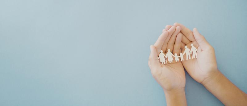 Hands holding multi-generation family paper