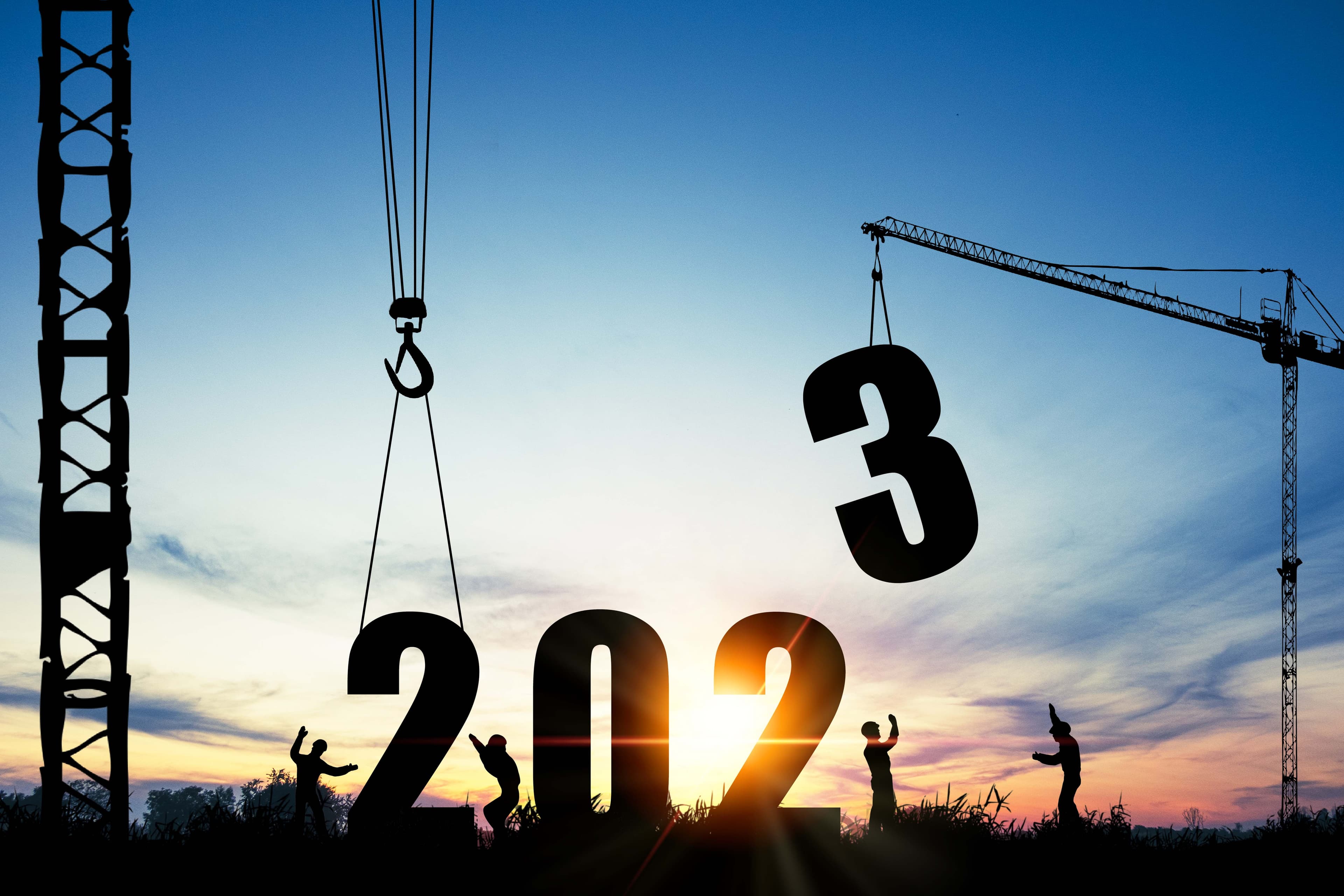 Workers with crane lifting the number 2023
