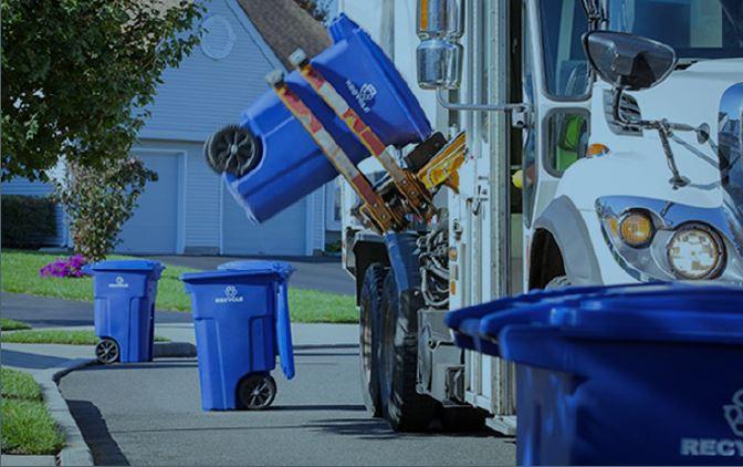 Truck picking up recycling in front of house