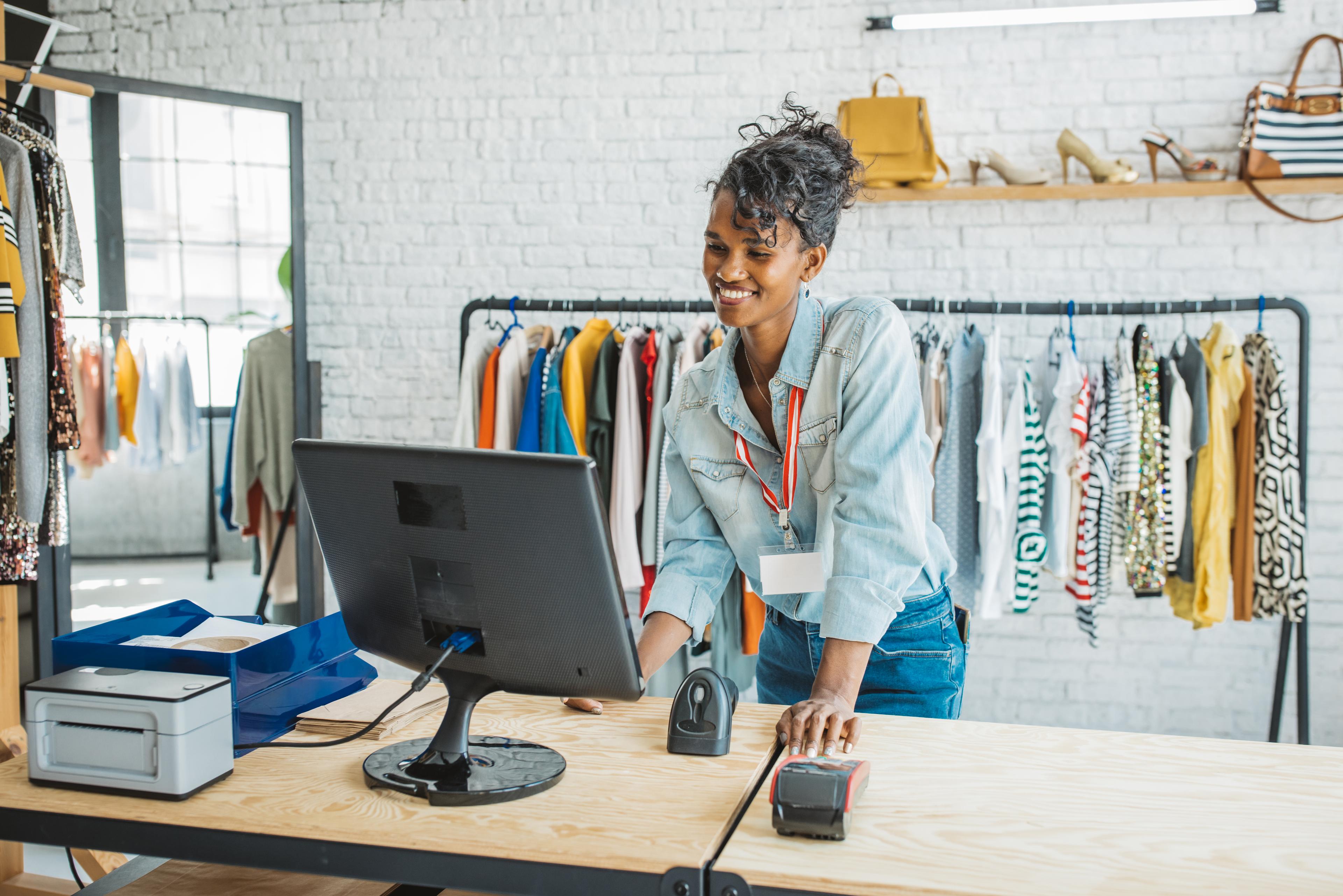 Ethnic small business owner smiling cheerfully in her shop.