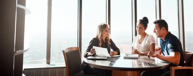 Group of professionals around a table laughing