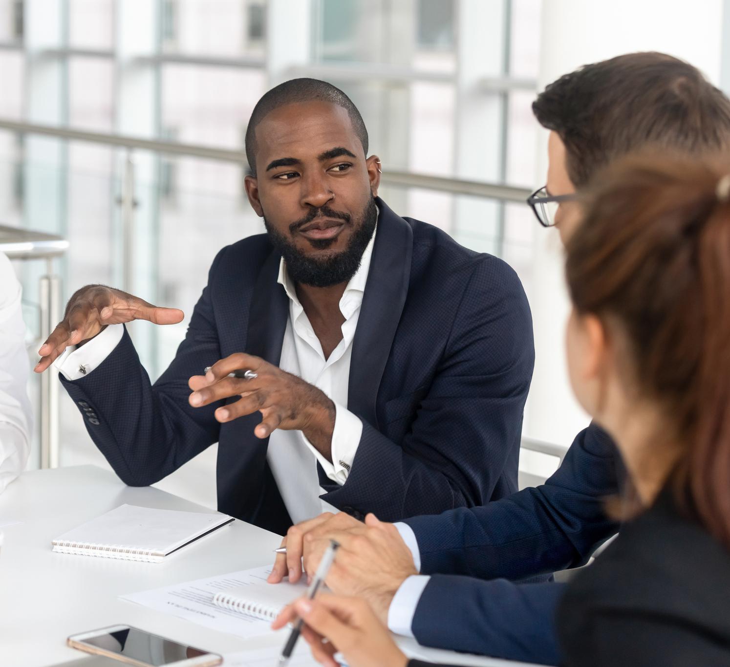 Black executive leading a meeting