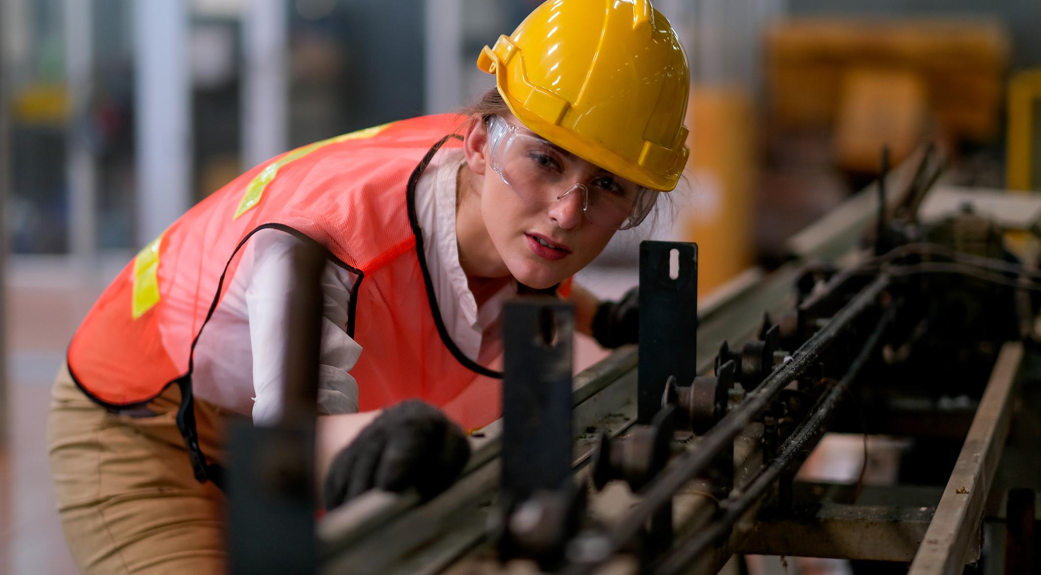 Woman looking at machinery.