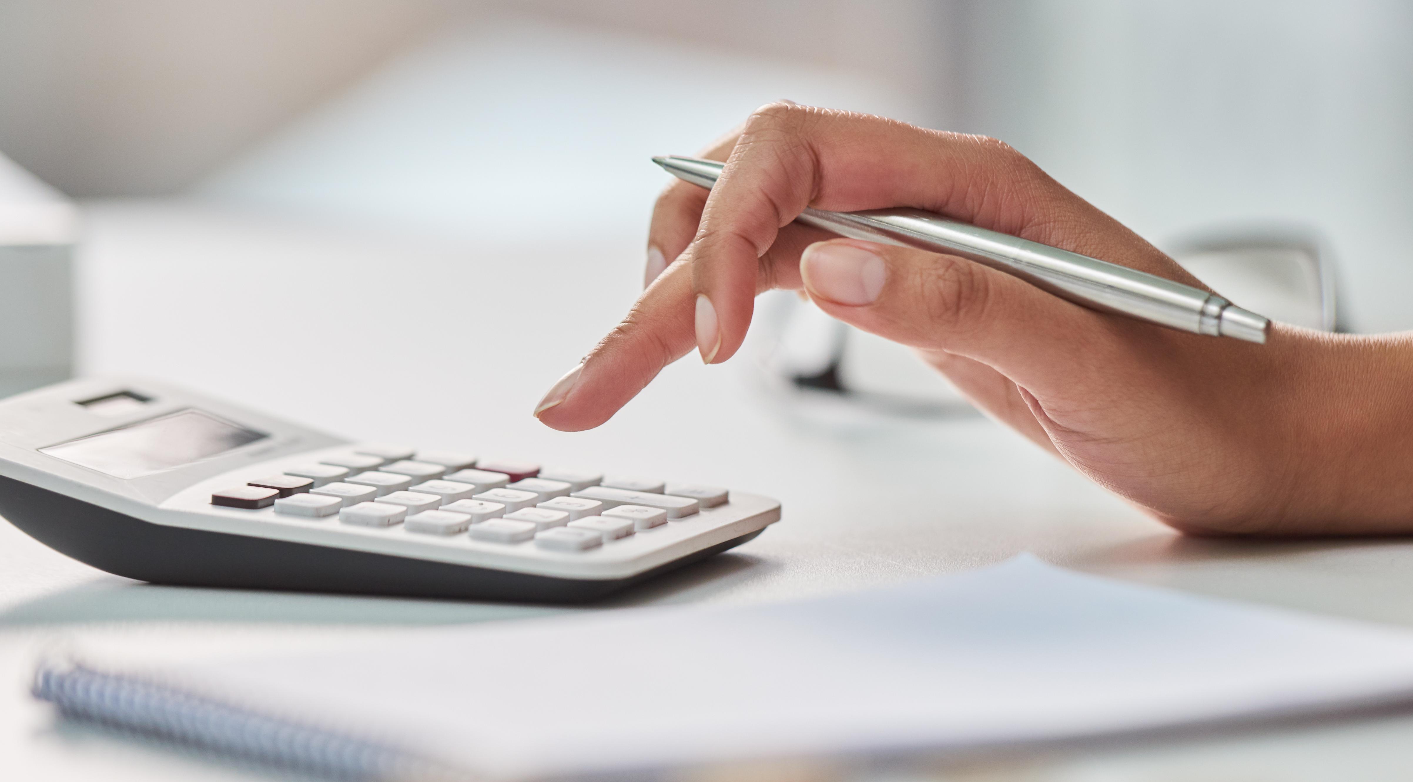 Woman using calculator.