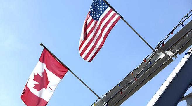 U.S. and Canadian flags.