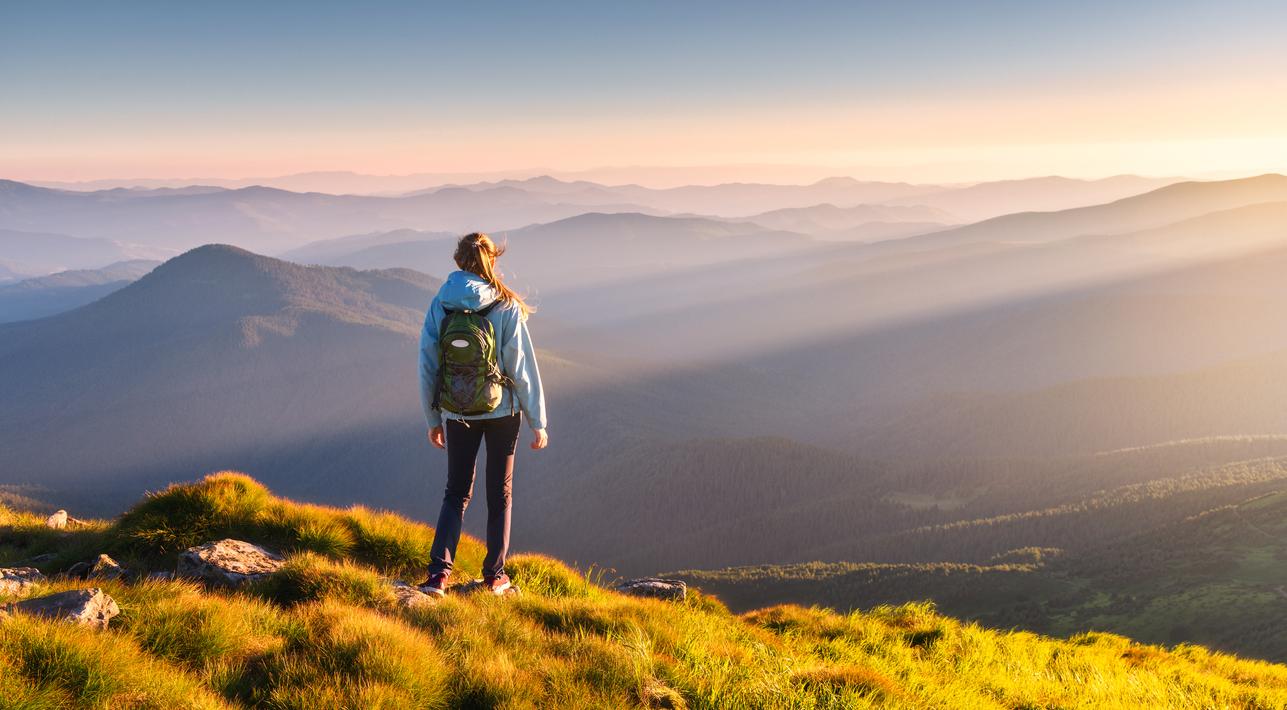 woman standing on hill. Click here to play video. 