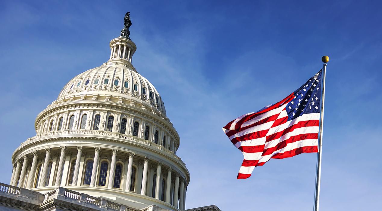 American flag waving with the Capitol Hill