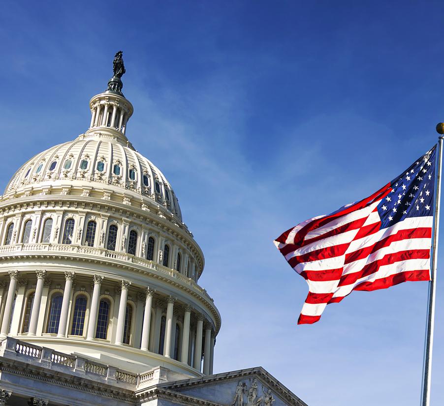 American flag waving with the Capitol Hill